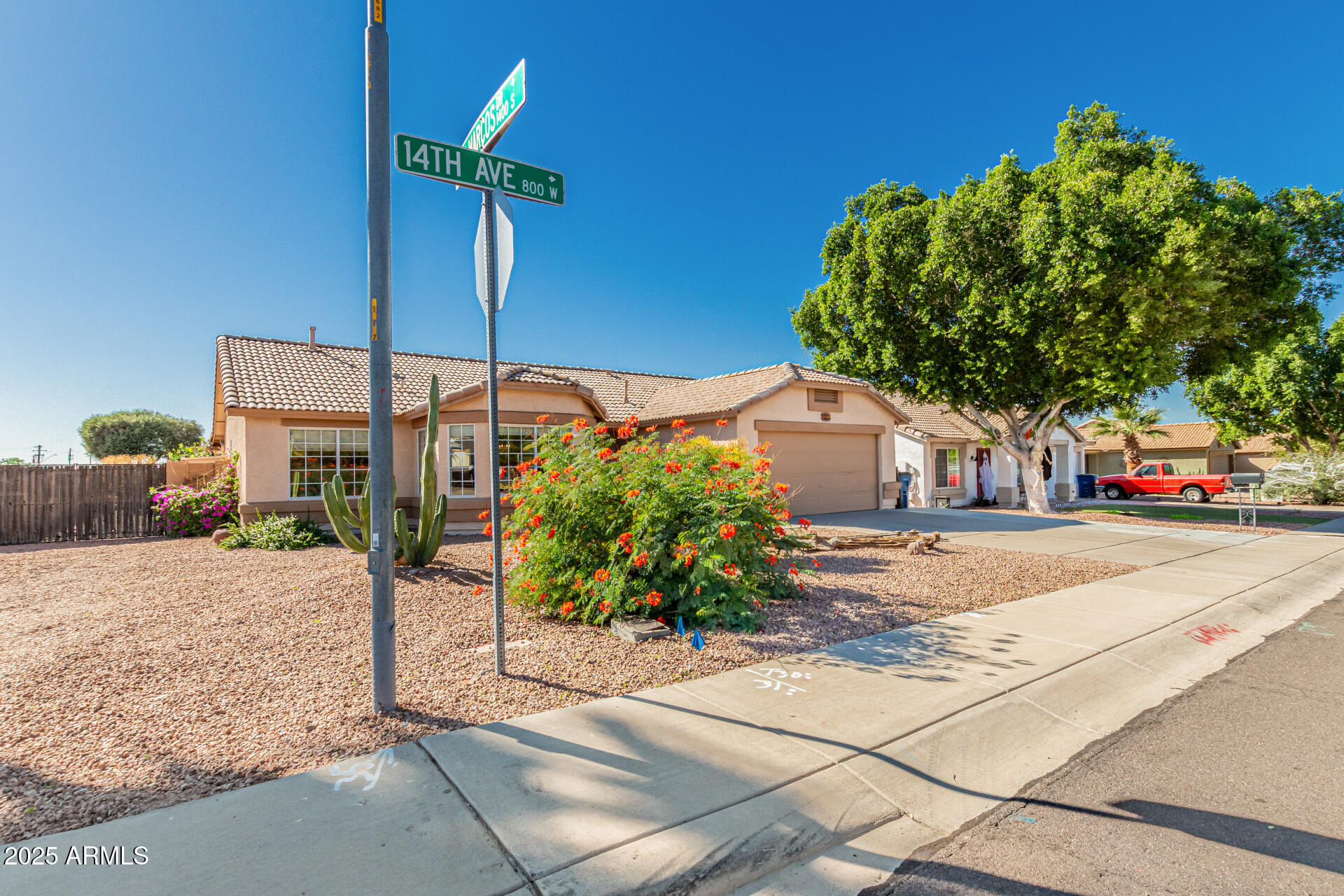 823 West 14th Avenue Apache Junction, AZ 85120 - Photo 4 of 32 a front view of a house with a yard and tree s