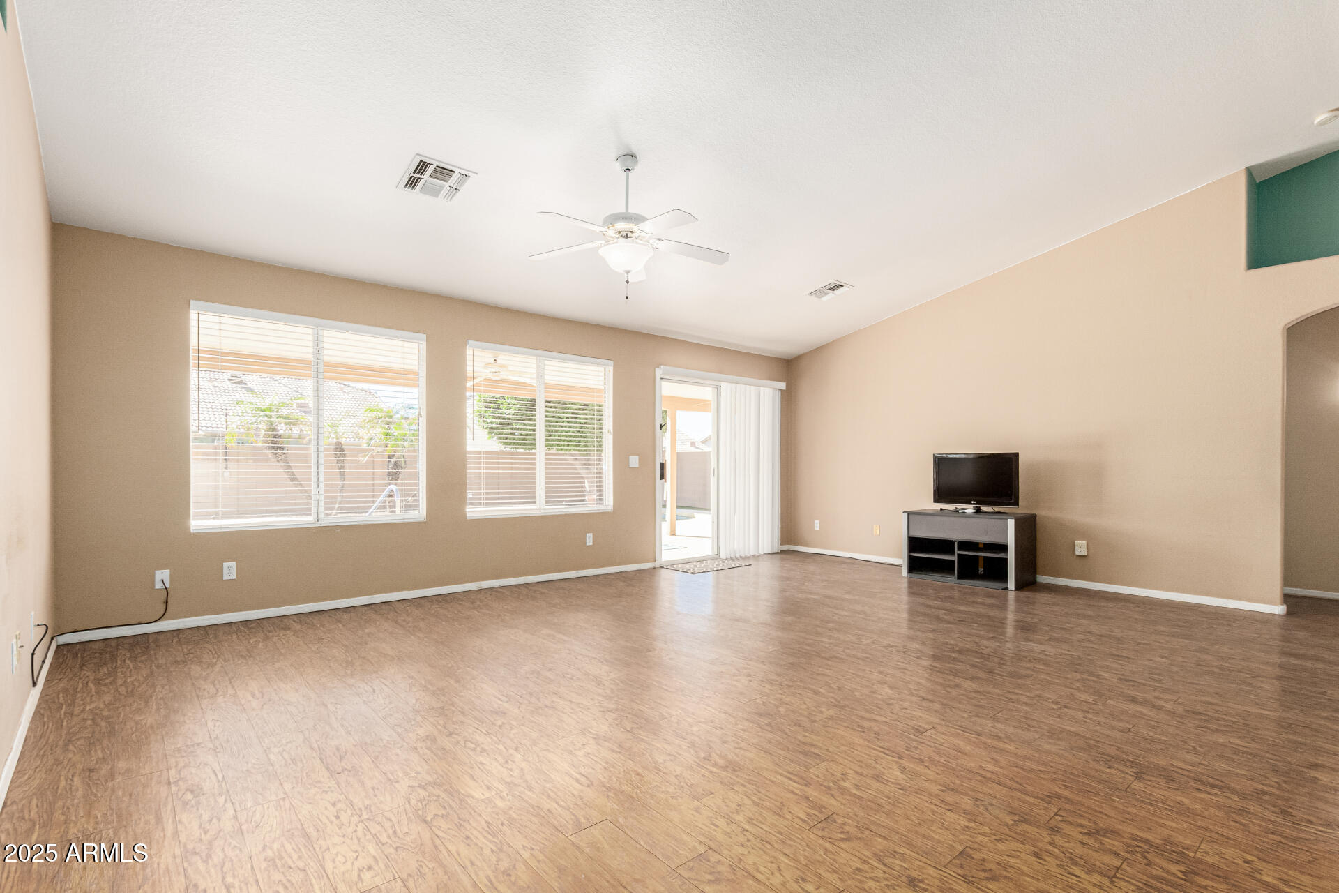 823 West 14th Avenue Apache Junction, AZ 85120 - Photo 8 of 32 a view of empty room with wooden floor and fan