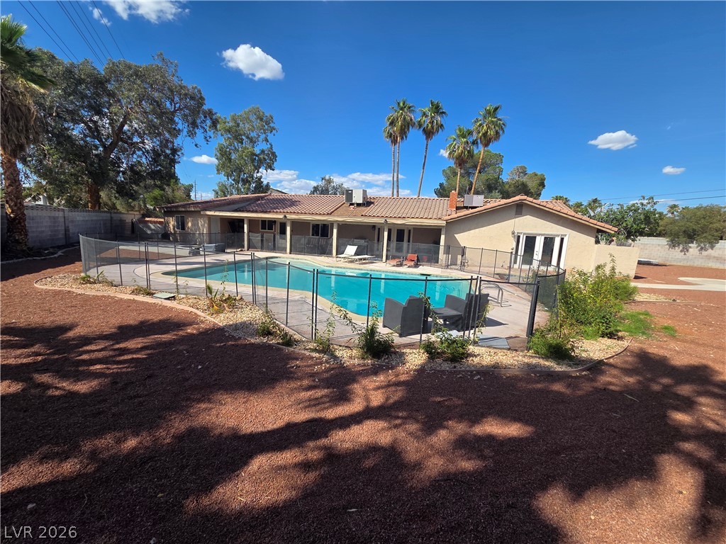 3381 Westwind Road Las Vegas, NV 89146 - Photo 8 of 52 An inviting private pool and surrounding paved patio complement the home's exterior.