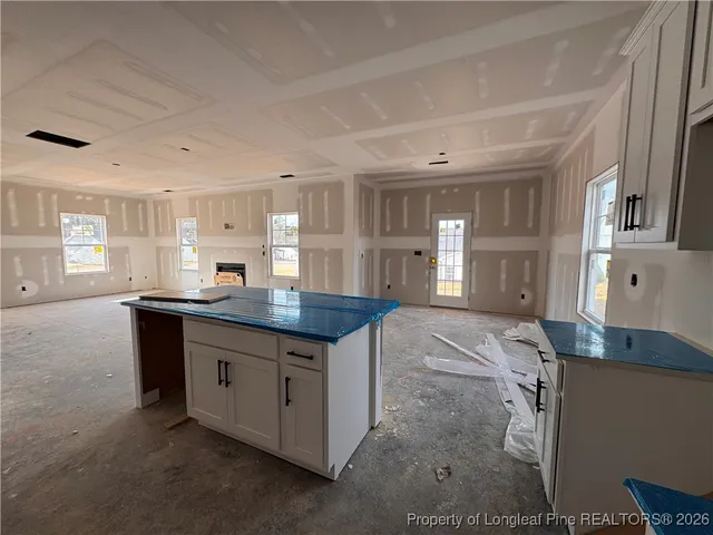 a kitchen with granite countertop a stove and a sink