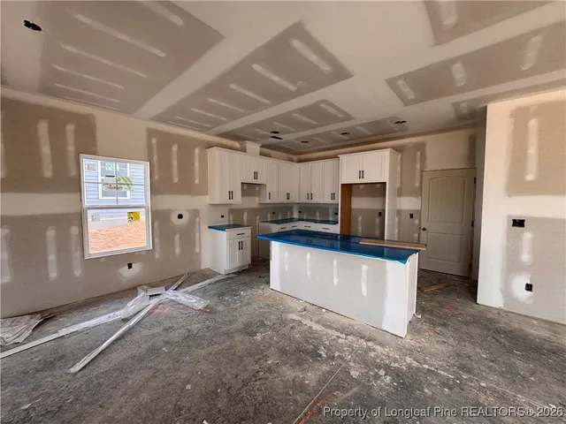 a kitchen with stainless steel appliances granite countertop a stove refrigerator sink and dishwasher with wooden floor