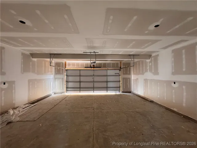 a view of empty room with wooden floor and windows