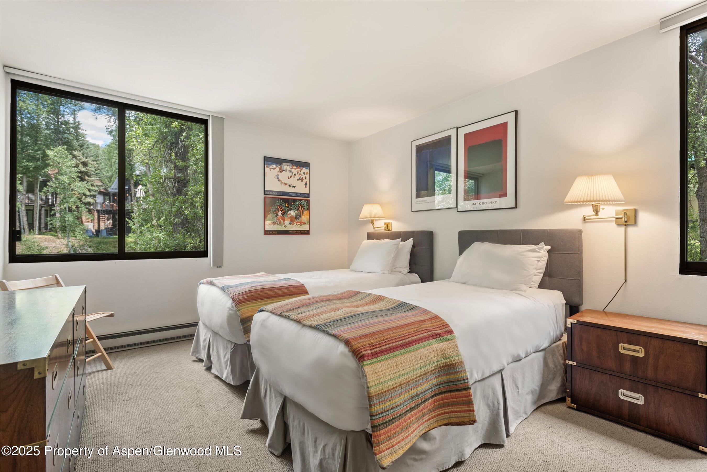 1024 East Hopkins Avenue, Unit 16 Aspen, CO 81611 - Photo 9 of 20 Guest Bedroom with Riverfront Views