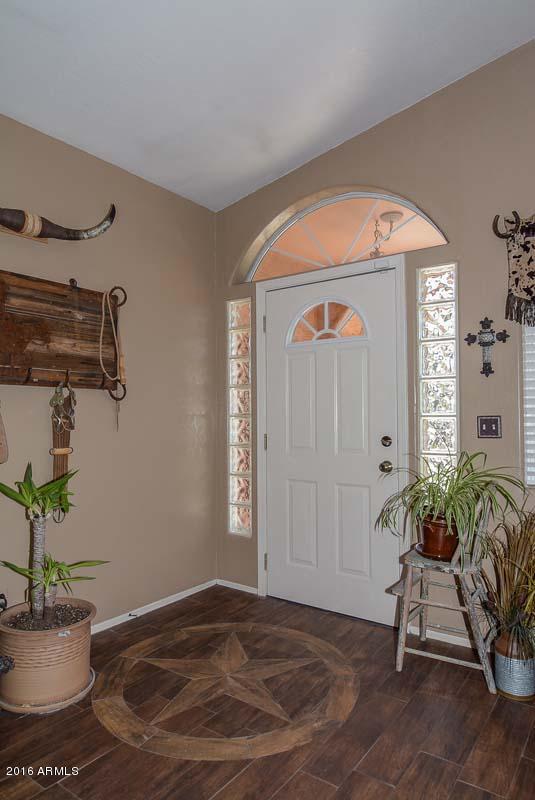 840 East Roberts Road Phoenix, AZ 85022 - Photo 14 of 52 a living room with a potted plant and a wooden floor