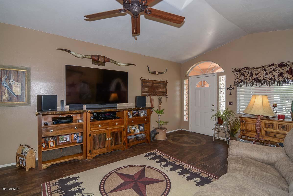 840 East Roberts Road Phoenix, AZ 85022 - Photo 17 of 52 a living room with furniture and a flat screen tv