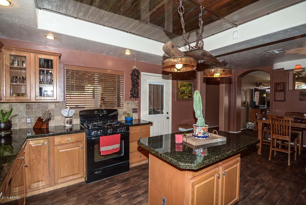 840 East Roberts Road Phoenix, AZ 85022 - Photo 23 of 52 a kitchen with stainless steel appliances granite countertop a sink stove and cabinets