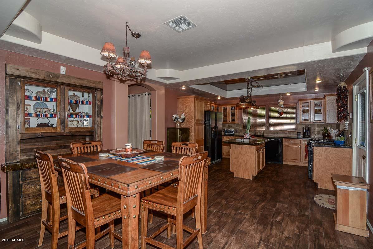 840 East Roberts Road Phoenix, AZ 85022 - Photo 25 of 52 a view of a dining room with furniture and chandelier