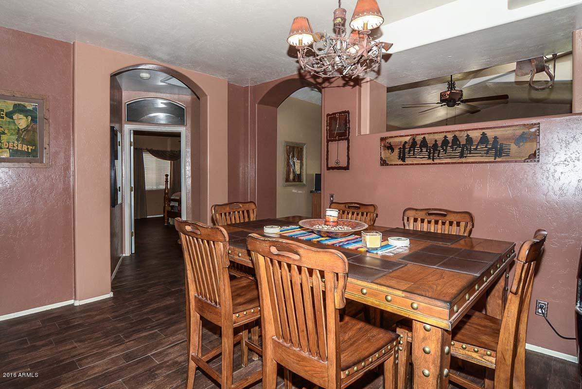 840 East Roberts Road Phoenix, AZ 85022 - Photo 27 of 52 a view of a dining room with furniture and chandelier