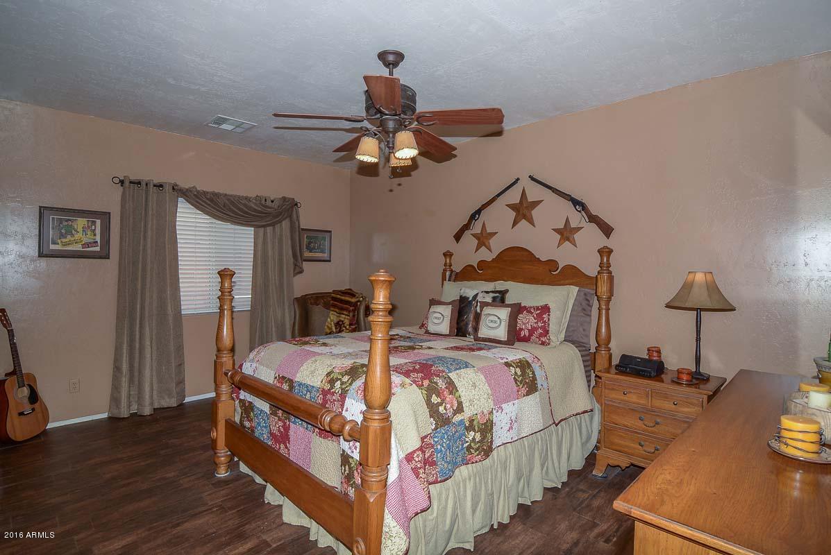 840 East Roberts Road Phoenix, AZ 85022 - Photo 28 of 52 a bedroom with a bed and a chandelier