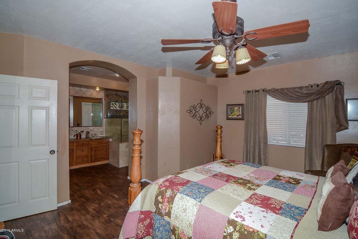 840 East Roberts Road Phoenix, AZ 85022 - Photo 29 of 52 a bedroom with a bed and a chandelier