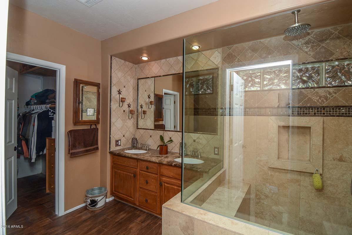 840 East Roberts Road Phoenix, AZ 85022 - Photo 32 of 52 a bathroom with a granite countertop sink mirror and shower