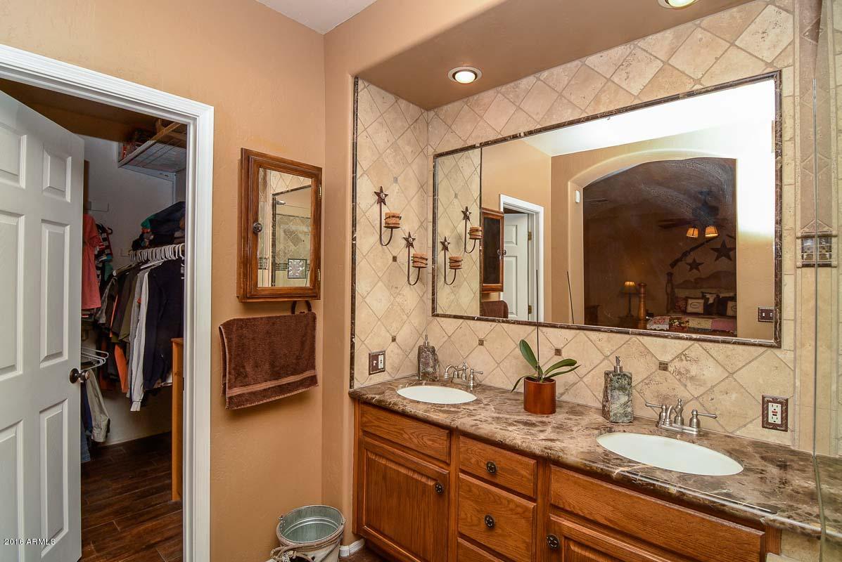 840 East Roberts Road Phoenix, AZ 85022 - Photo 33 of 52 a en suite bathroom with a granite countertop sink and a mirror