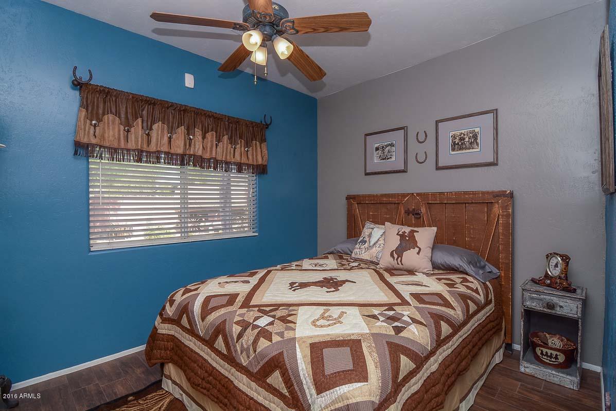 840 East Roberts Road Phoenix, AZ 85022 - Photo 35 of 52 a bedroom with a bed and a chandelier