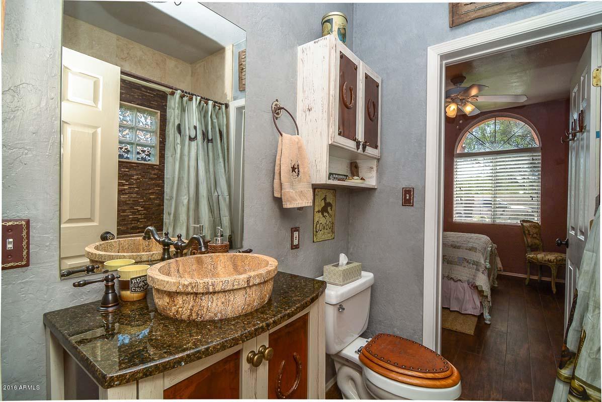 840 East Roberts Road Phoenix, AZ 85022 - Photo 39 of 52 a bathroom with a granite countertop sink toilet and shower