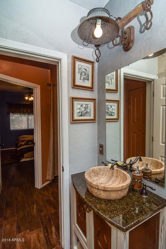 840 East Roberts Road Phoenix, AZ 85022 - Photo 41 of 52 a bathroom with a granite countertop sink and a mirror