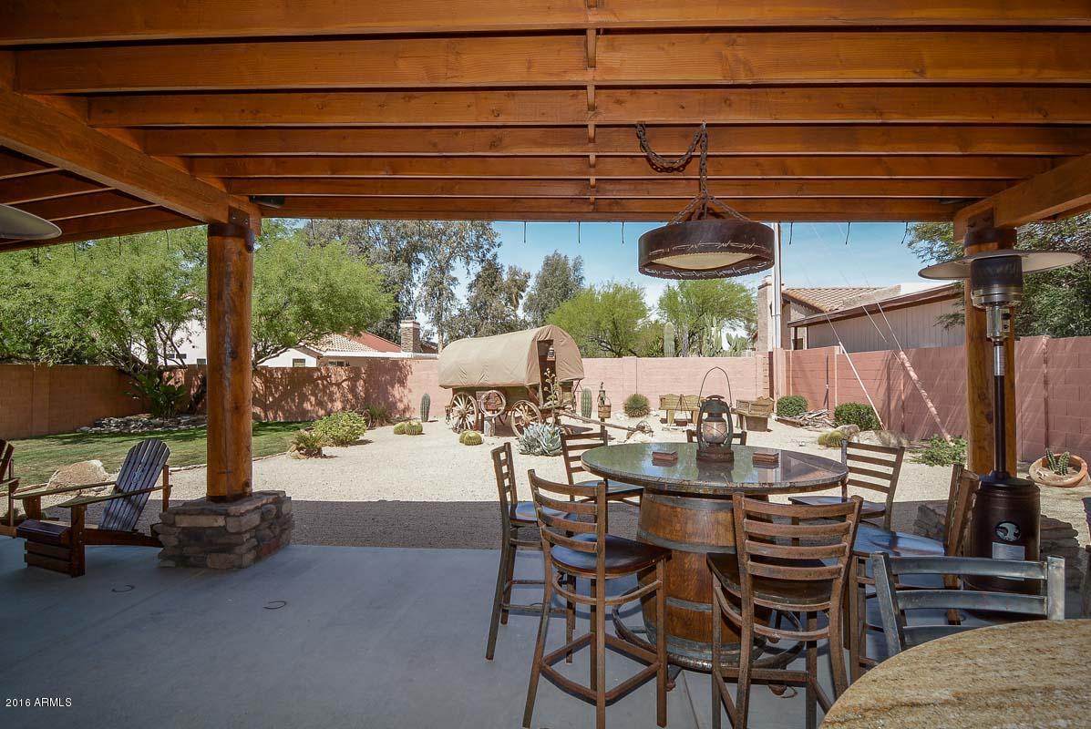 840 East Roberts Road Phoenix, AZ 85022 - Photo 47 of 52 a view of a patio with table and chairs under an umbrella