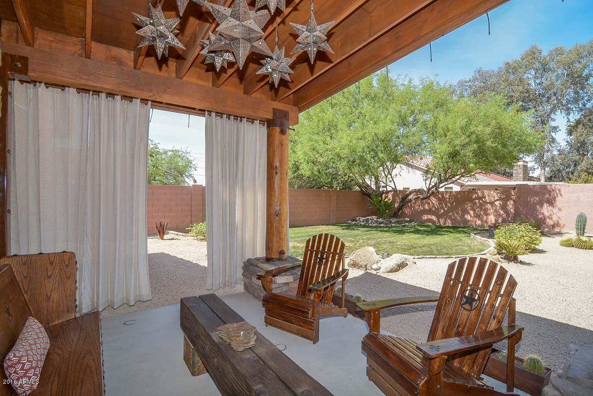 840 East Roberts Road Phoenix, AZ 85022 - Photo 49 of 52 a view of a patio with a table chairs and a yard