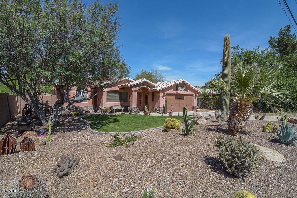 840 East Roberts Road Phoenix, AZ 85022 - Photo 8 of 52 a view of a house with a yard and large trees