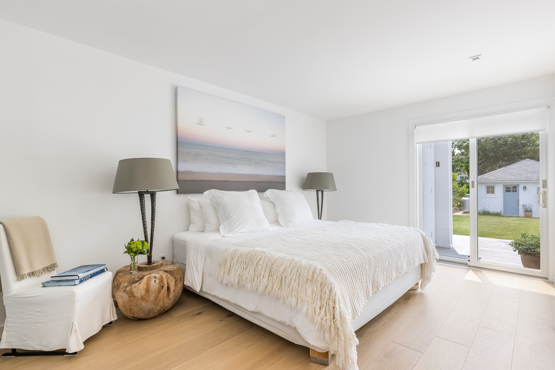 35 Hampton Road Sag Harbor, NY 11963 - Photo 19 of 27 a bedroom with a bed and a lamp