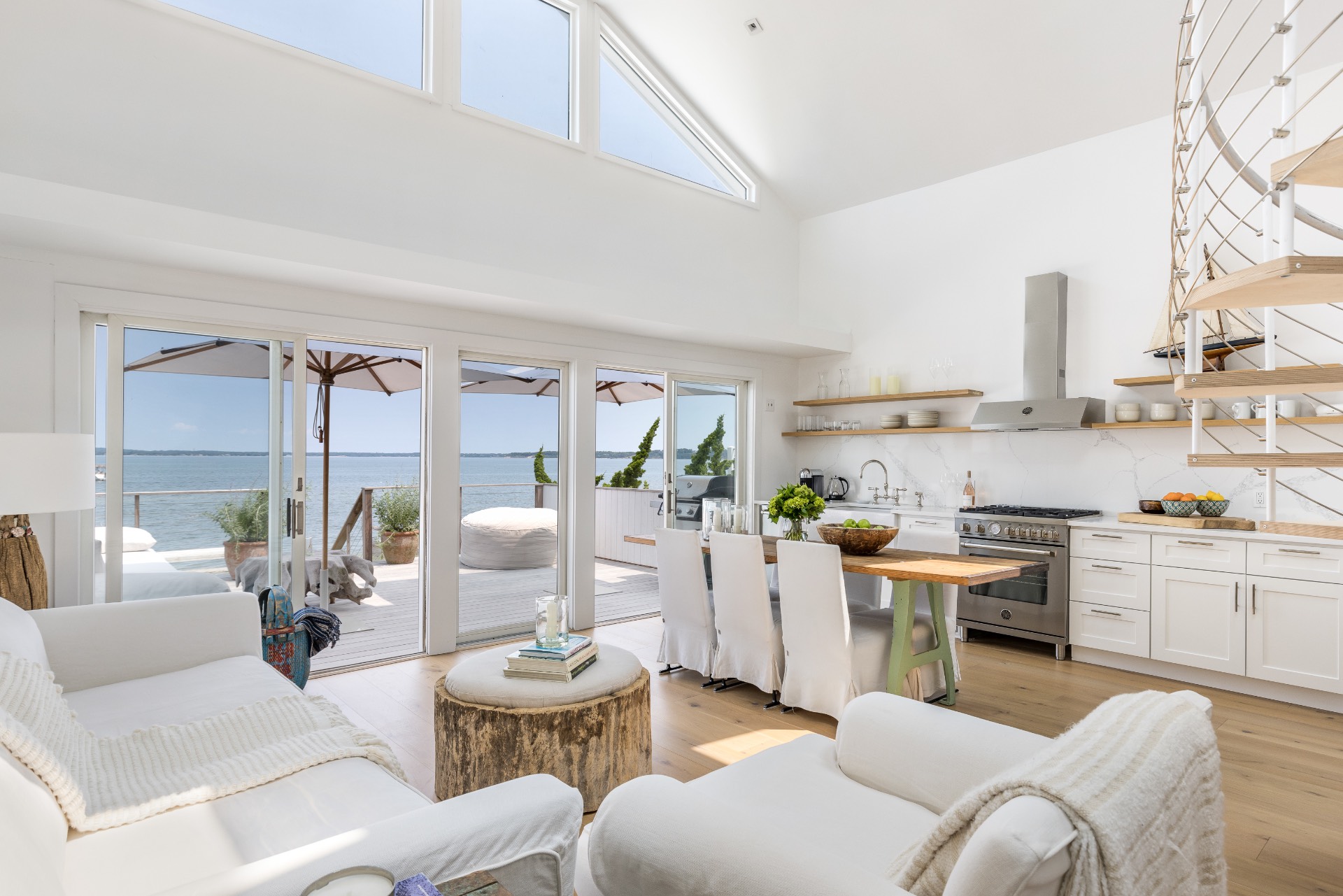 35 Hampton Road Sag Harbor, NY 11963 - Photo 8 of 27 a living room with furniture a large window and kitchen view