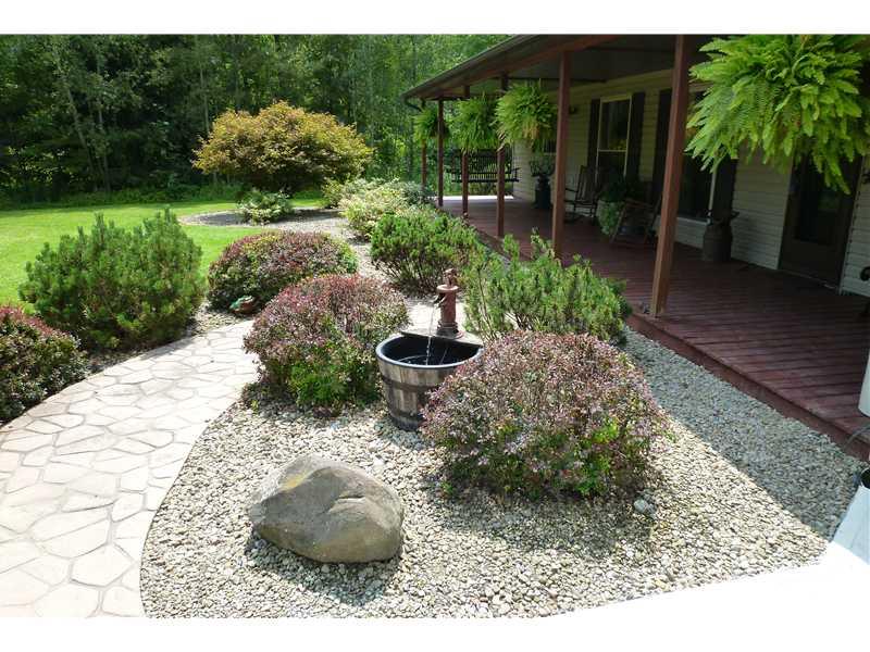781 Henderson Station Road Stoneboro, PA 16153 - Photo 2 of 13 Exterior Front. An example of the tasteful landscaping both in front of house and around the pool in rear.