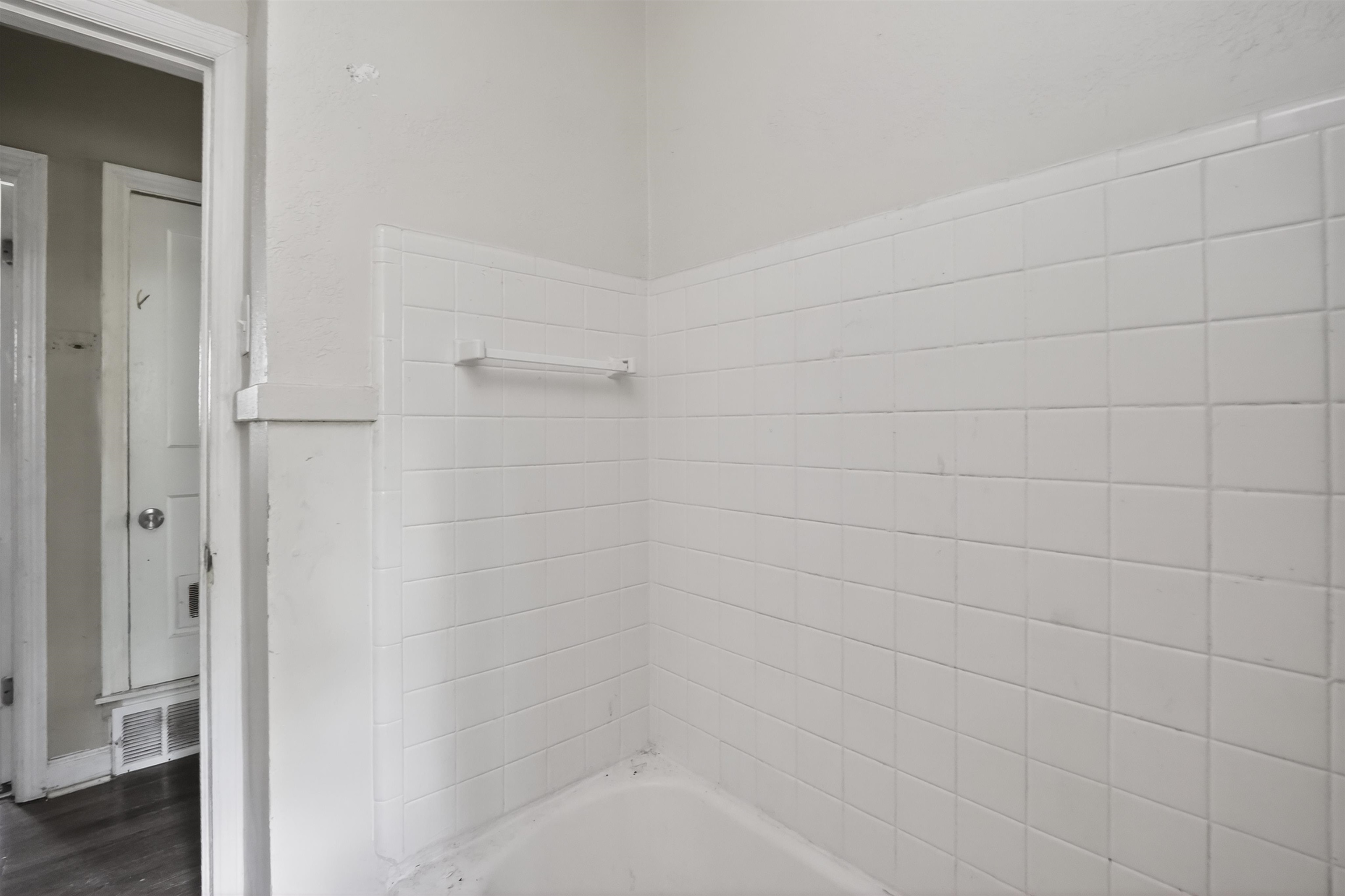 949 Sumter Street Memphis, TN 38122 - Photo 27 of 33 White subway tile shower surround with integrated soap dish and a towel bar