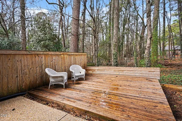 a view of balcony with wooden floor and fence