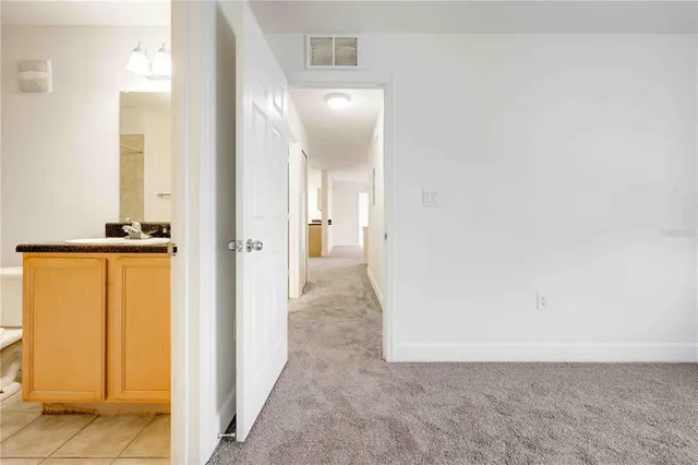 a large kitchen with granite countertop a refrigerator and a sink