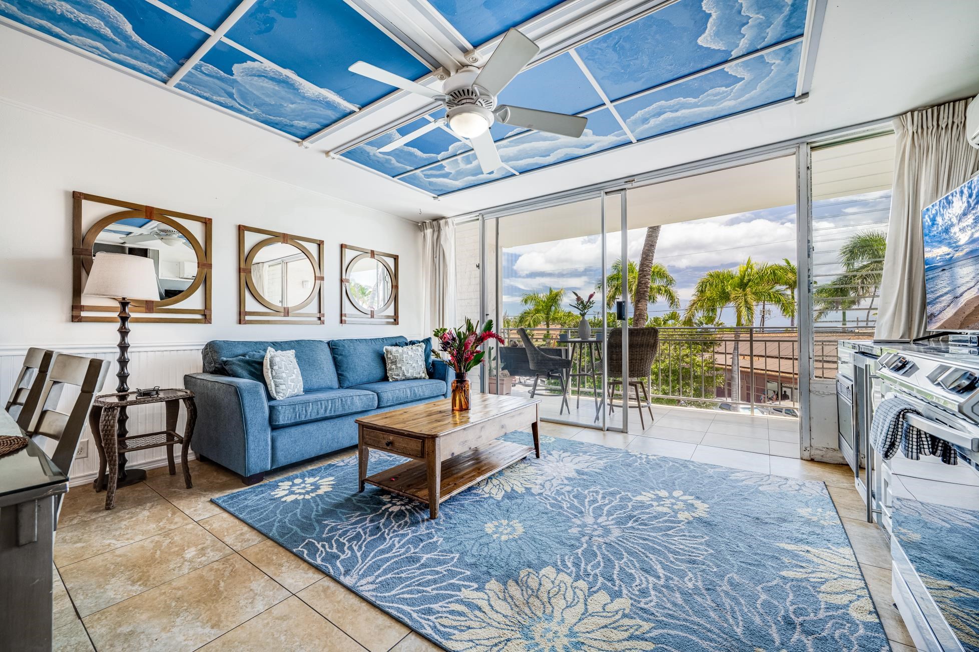a living room with furniture and a floor to ceiling window