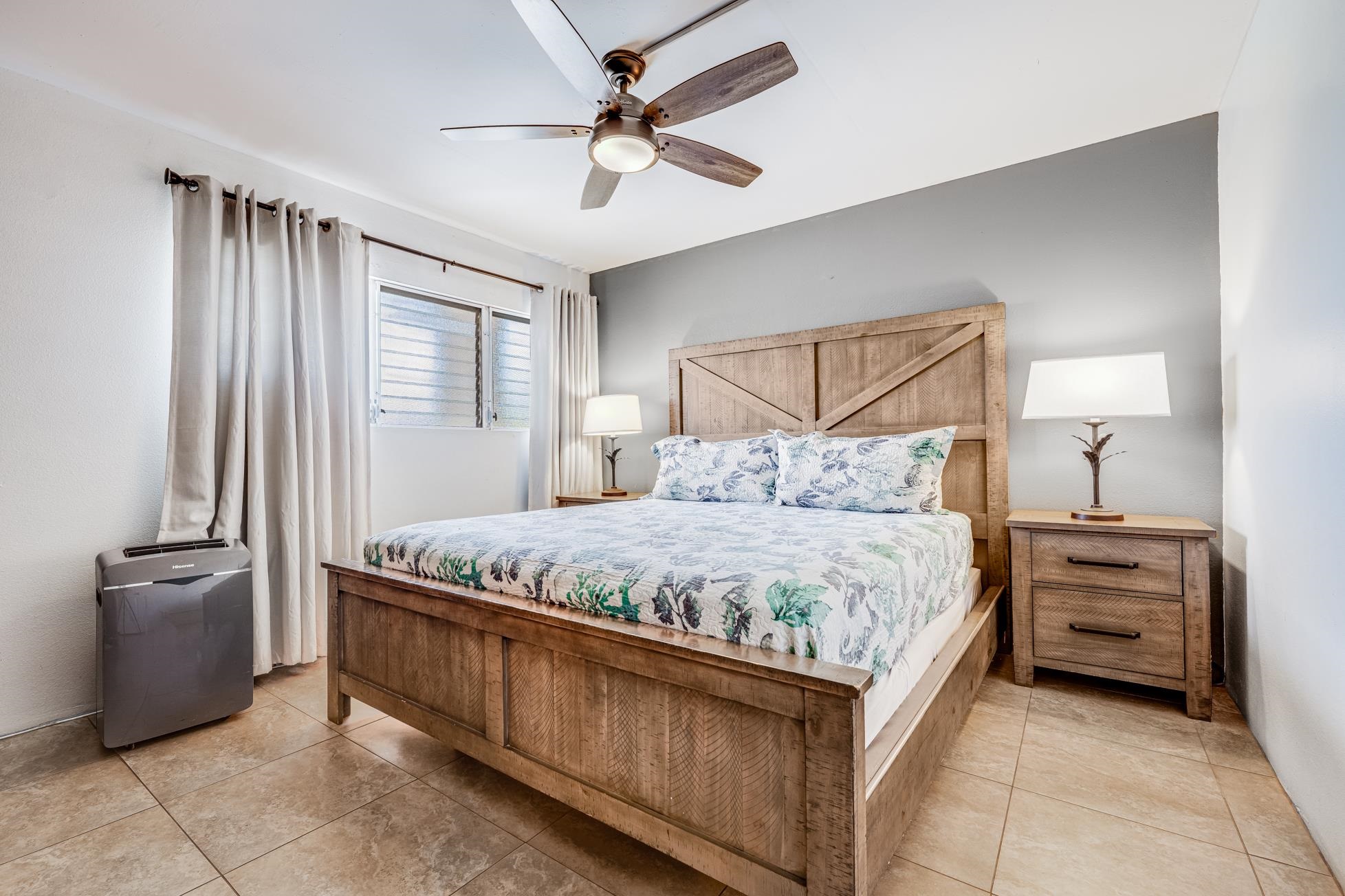 1993 South Kihei Road, Unit 311 Kihei, HI 96753 - Photo 13 of 31 a bedroom with a bed and a chandelier