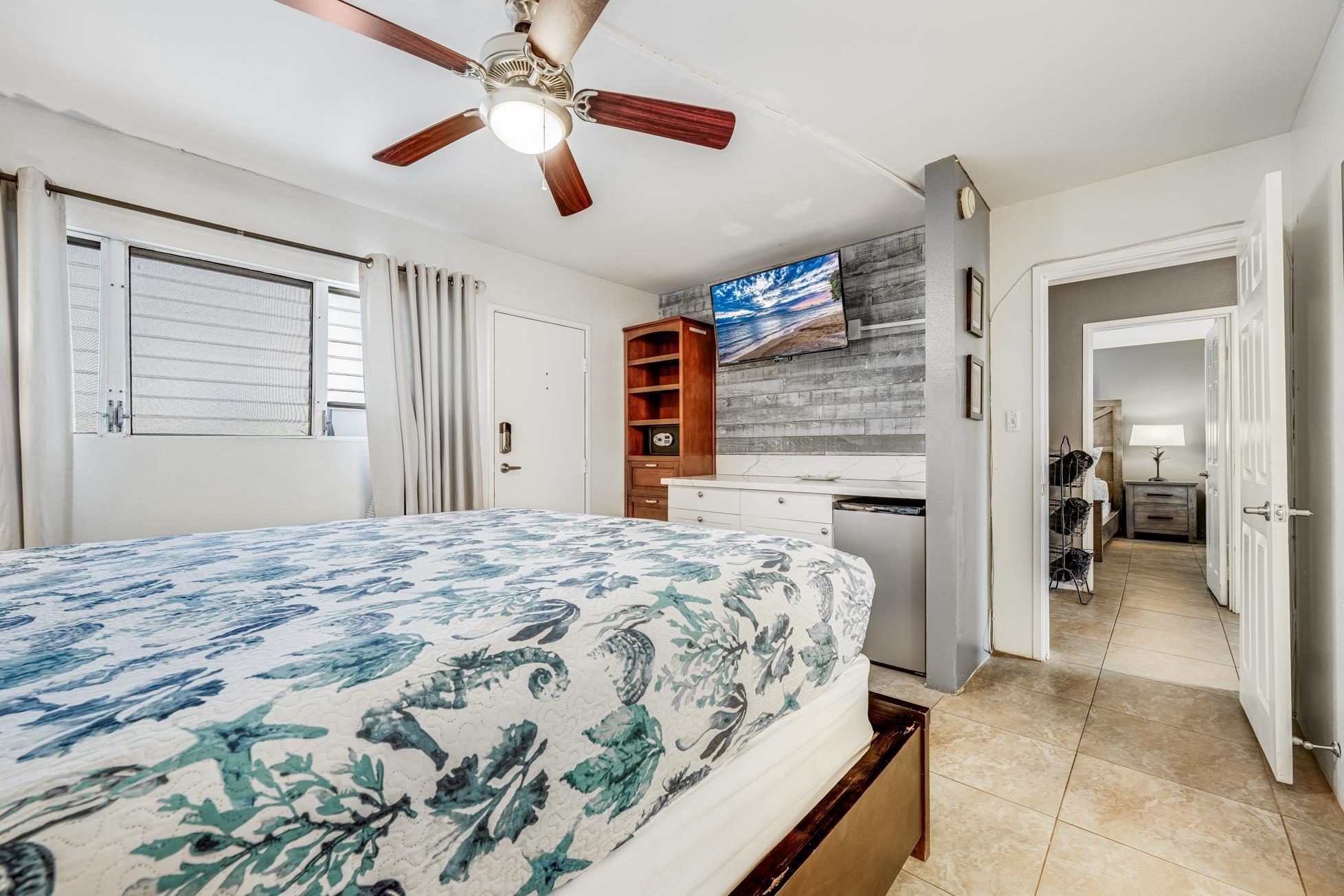 1993 South Kihei Road, Unit 311 Kihei, HI 96753 - Photo 17 of 31 a bedroom with a bed and a chandelier