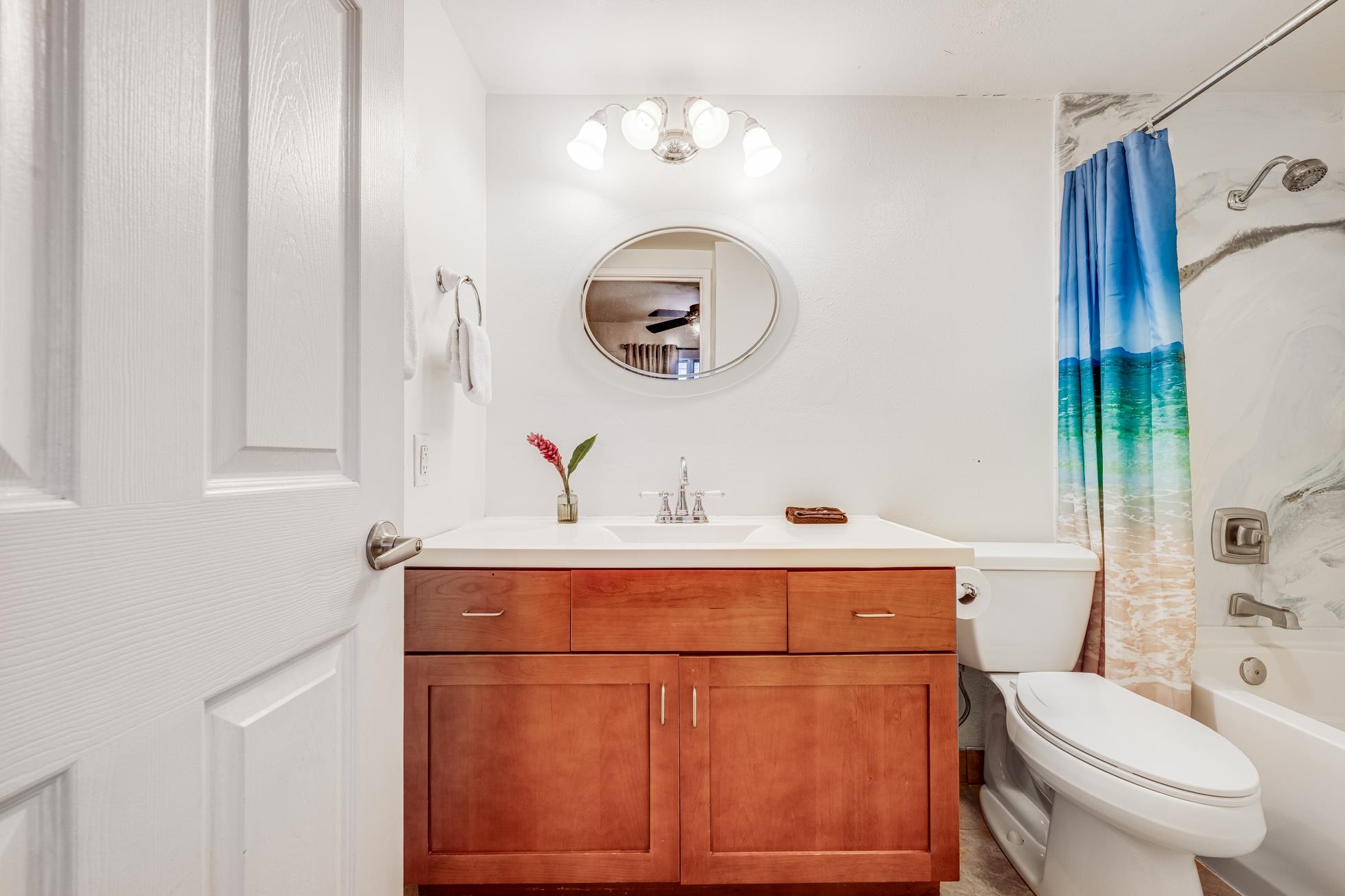1993 South Kihei Road, Unit 311 Kihei, HI 96753 - Photo 20 of 31 a bathroom with a toilet a sink and mirror