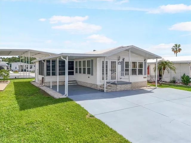 a view of a house with a yard and sitting area