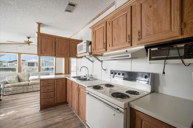a kitchen with a sink stove and cabinets
