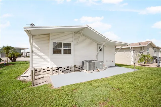 a swimming pool with outdoor seating and yard