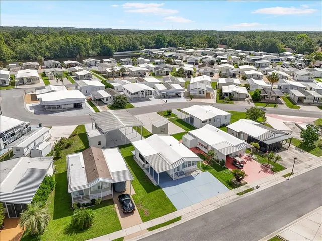 an aerial view of residential houses with yard
