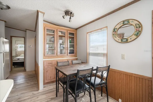 a view of a dining room with furniture and a window