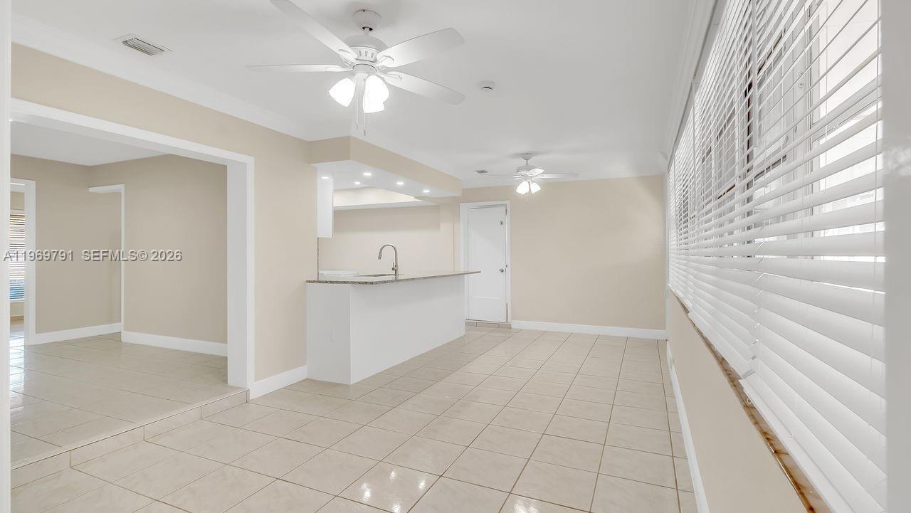 5300 Grant Street Hollywood, FL 33021 - Photo 11 of 46 a view of an empty room with kitchen and a window