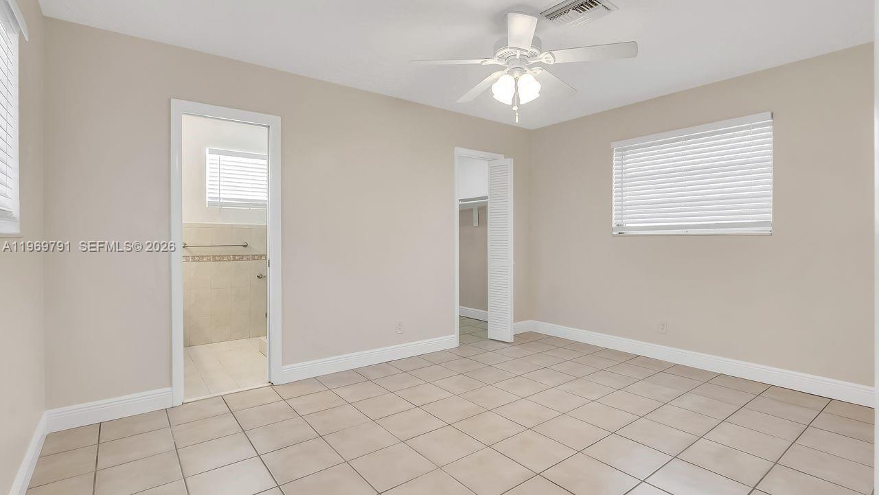 5300 Grant Street Hollywood, FL 33021 - Photo 19 of 46 a view of an empty room with window and chandelier fan