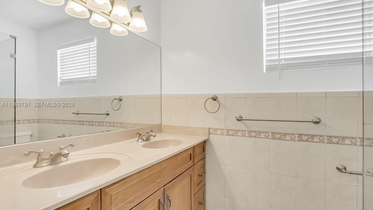 5300 Grant Street Hollywood, FL 33021 - Photo 20 of 46 a bathroom with a sink a vanity and a mirror