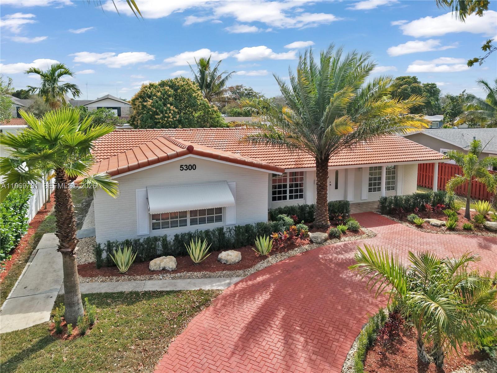 5300 Grant Street Hollywood, FL 33021 - Photo 2 of 46 a front view of a house with garden