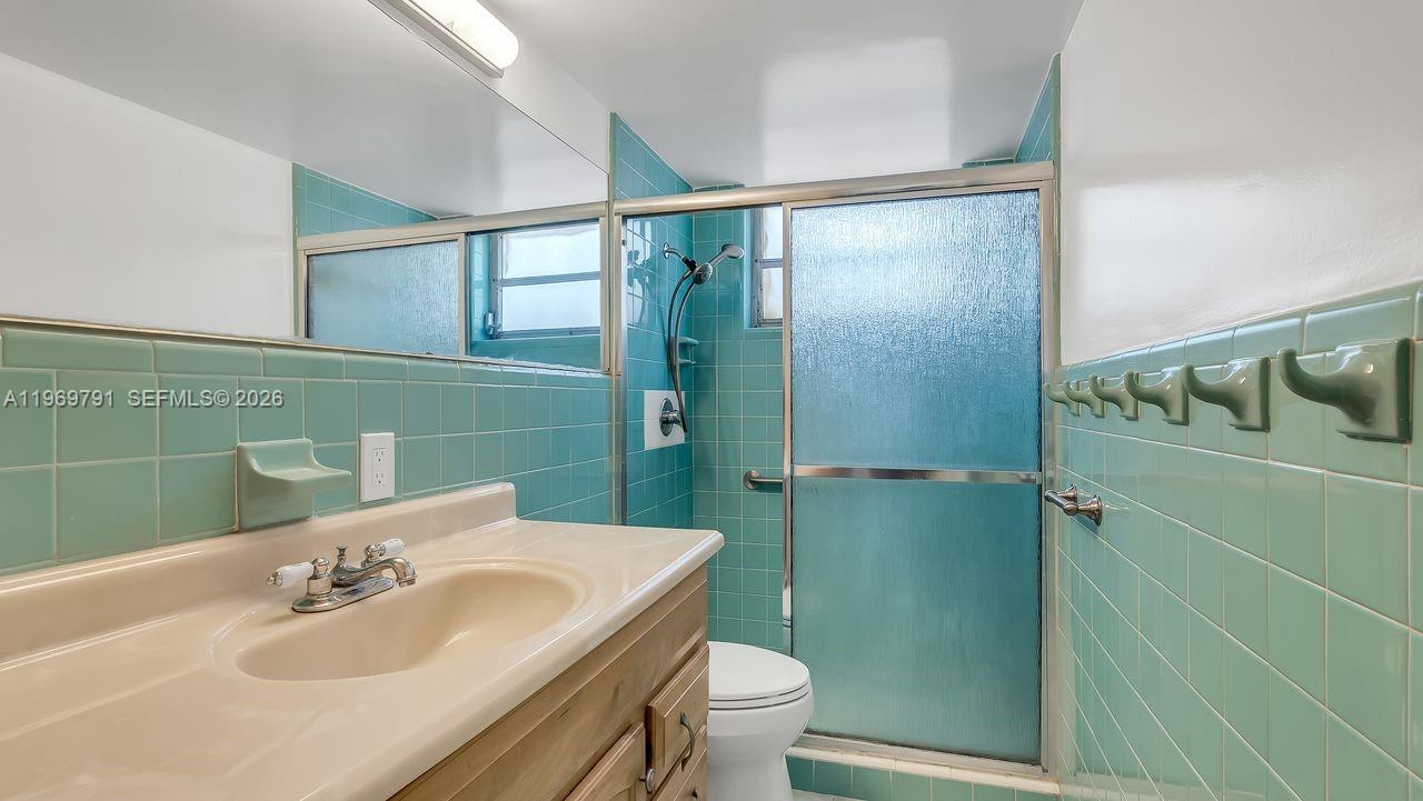 5300 Grant Street Hollywood, FL 33021 - Photo 26 of 46 a bathroom with a sink and mirror with toilet