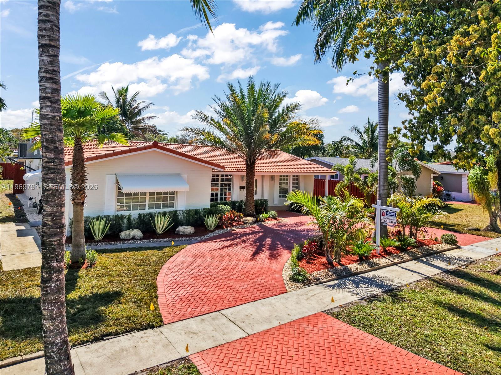 5300 Grant Street Hollywood, FL 33021 - Photo 3 of 46 a front view of a house with yard patio and swimming pool