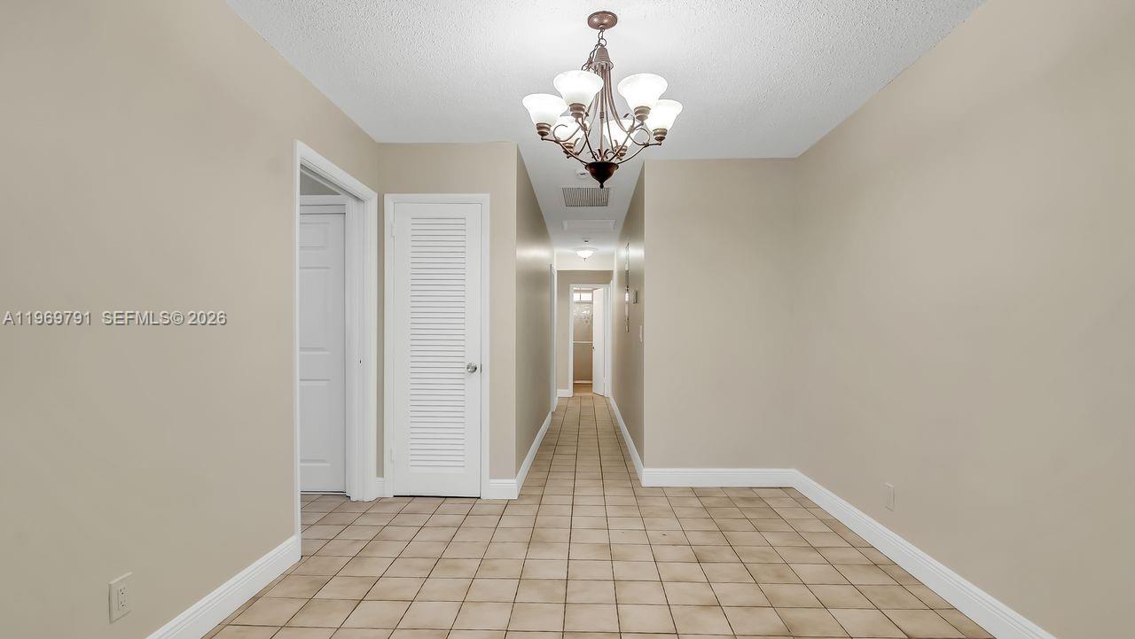 5300 Grant Street Hollywood, FL 33021 - Photo 33 of 46 a view of entryway with chandelier and glass door