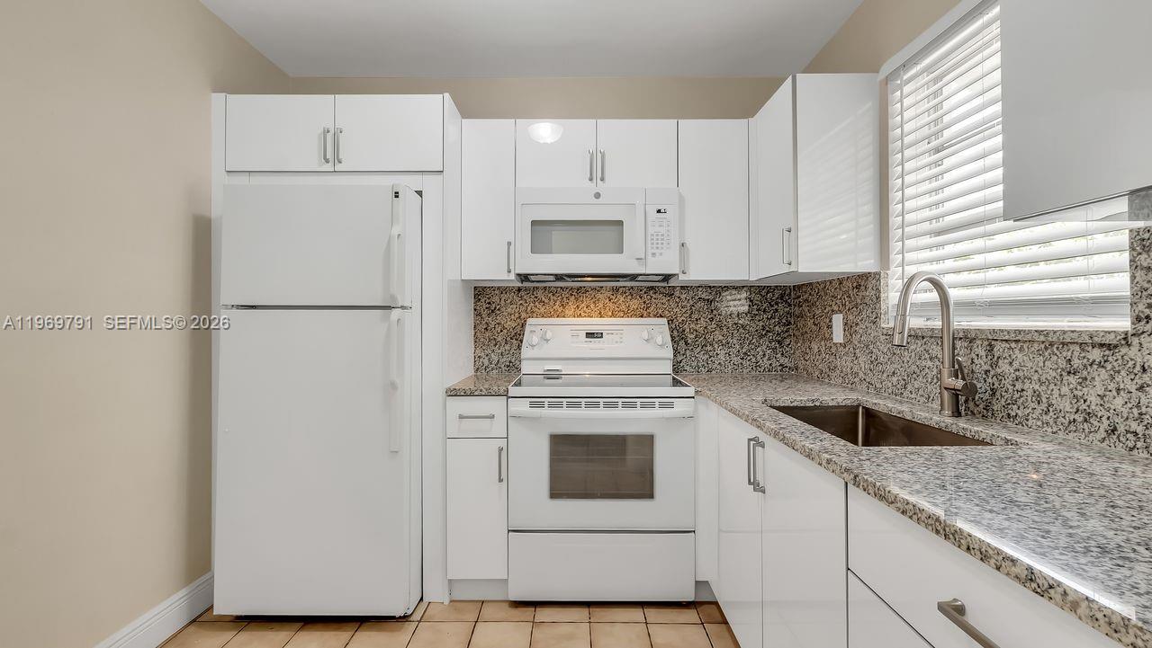 5300 Grant Street Hollywood, FL 33021 - Photo 36 of 46 a kitchen with cabinets appliances a sink and a window