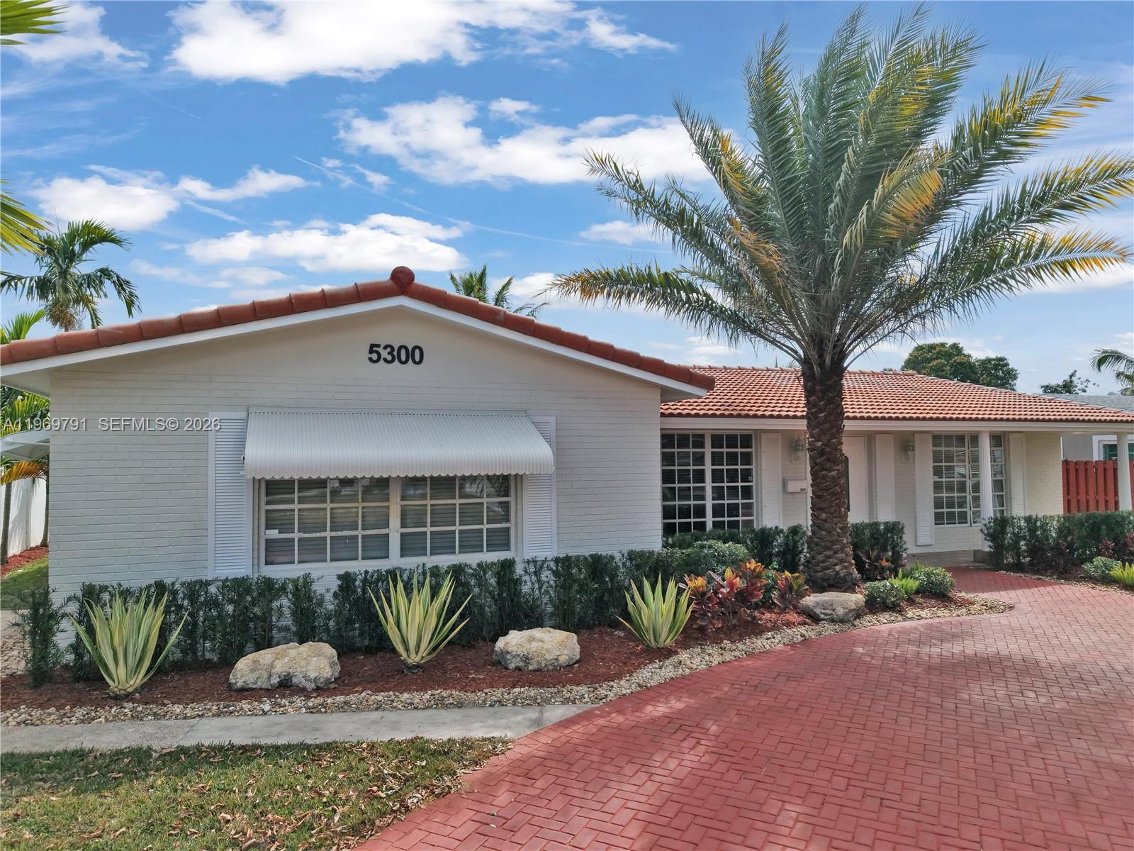 5300 Grant Street Hollywood, FL 33021 - Photo 5 of 46 a front view of a house with garden