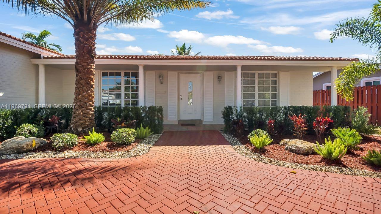 5300 Grant Street Hollywood, FL 33021 - Photo 7 of 46 a front view of a house with a garden