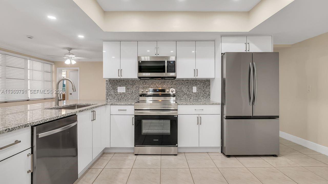 5300 Grant Street Hollywood, FL 33021 - Photo 9 of 46 a kitchen with a refrigerator sink and microwave