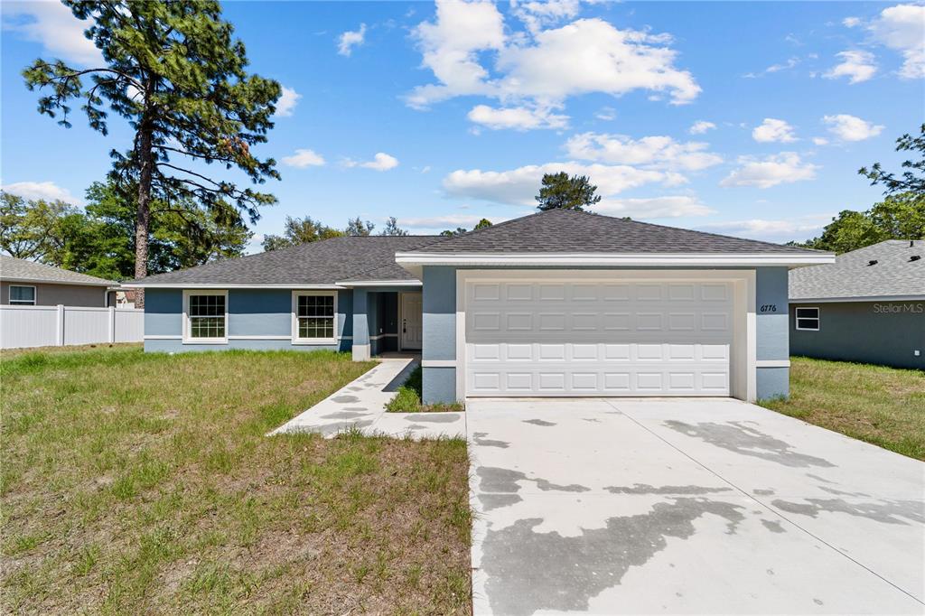 6776 Southwest 151 Loop Ocala, FL 34473 - Photo 1 of 1 a front view of a house with a yard