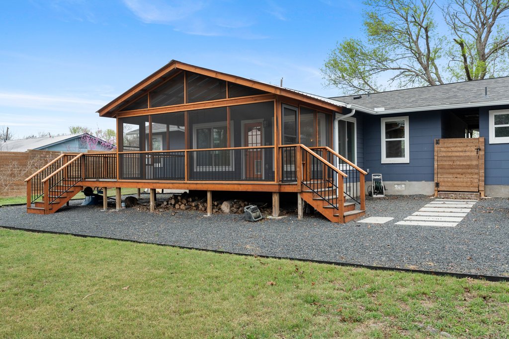 3404 Touchstone Street Austin, TX 78723 - Photo 27 of 33 Back of property with a sunroom, a wooden deck, and a yard
